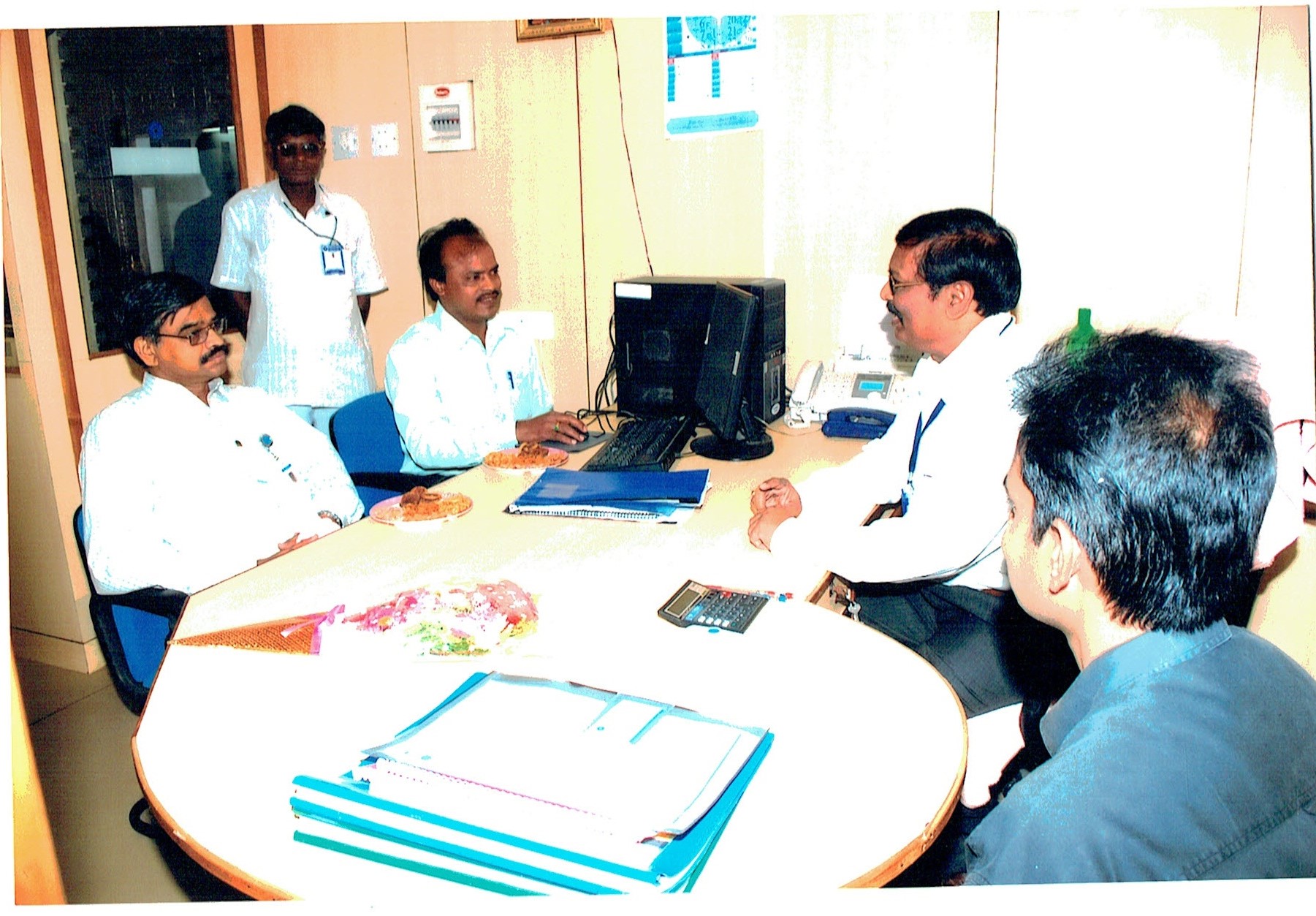 In discussion with colleagues at the branch.