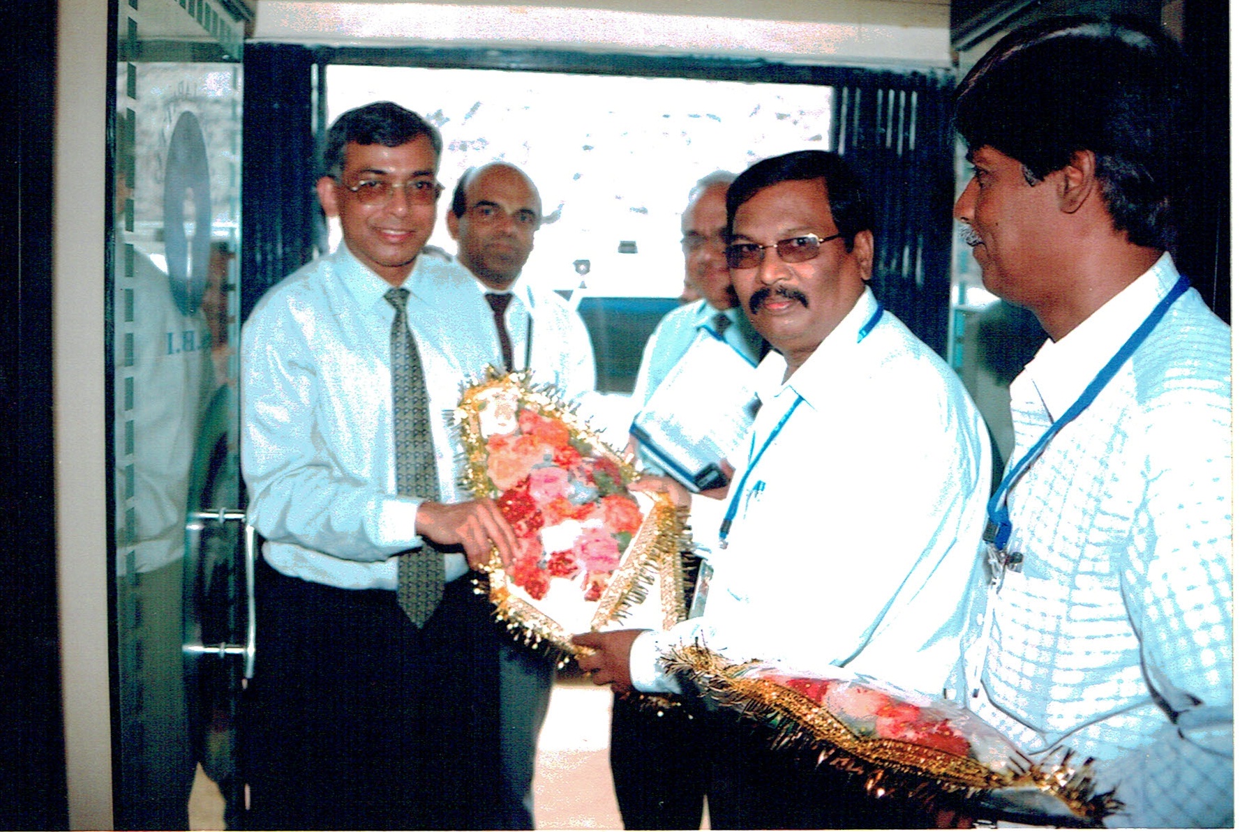 Felicitating a senior officer at the branch.